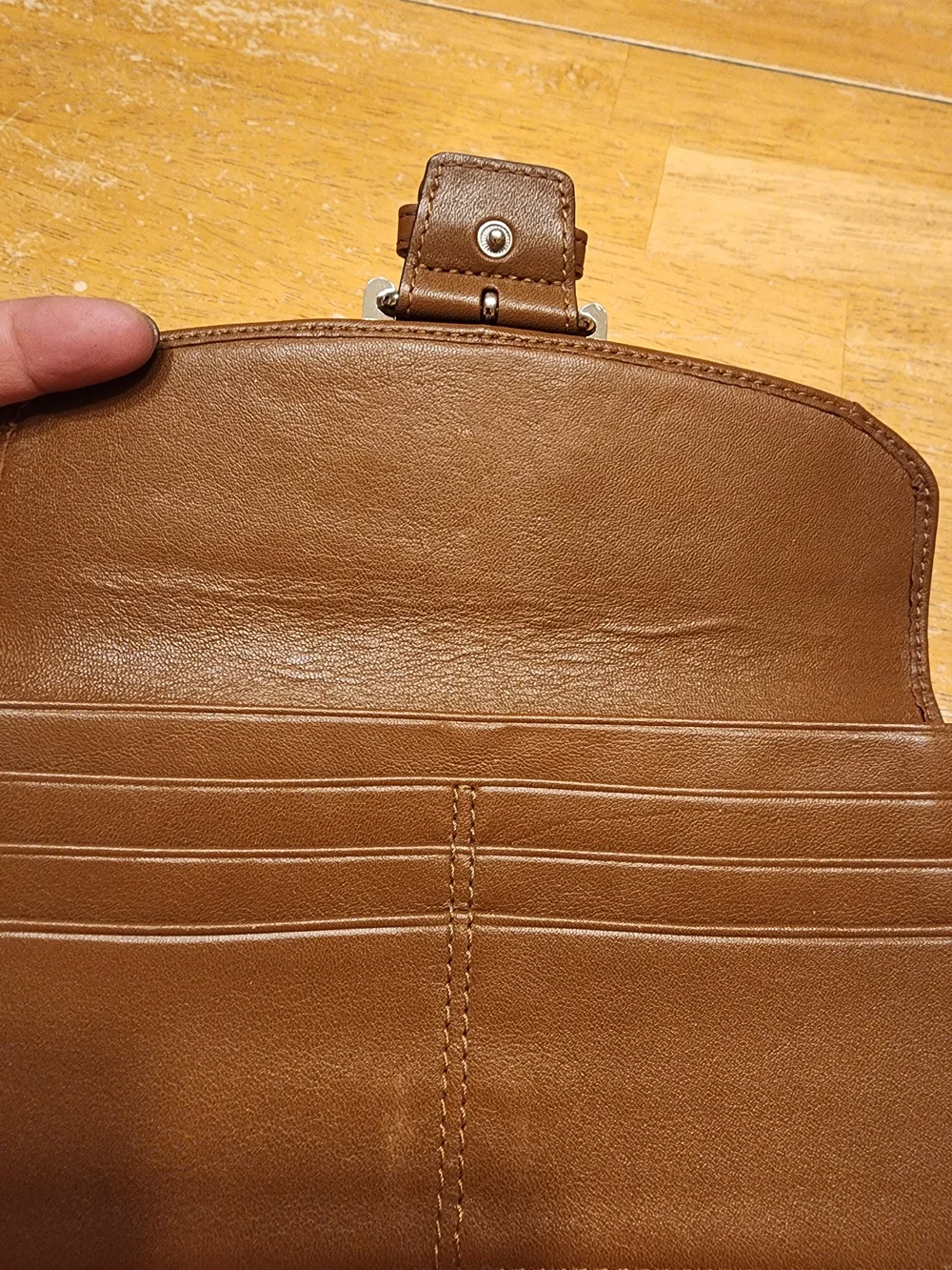 vintage Coach Soho Buckle Wallet crafted in brown leather prominent front Buckle